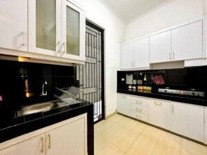The kitchen is fully equipped for your cooking needs. It includes a modern stove and quality chinaware for your convenience. With practical storage options, it's designed to make meal preparation easy and efficient. Enjoy cooking in this functional space at Nuansa Swadarma Residence